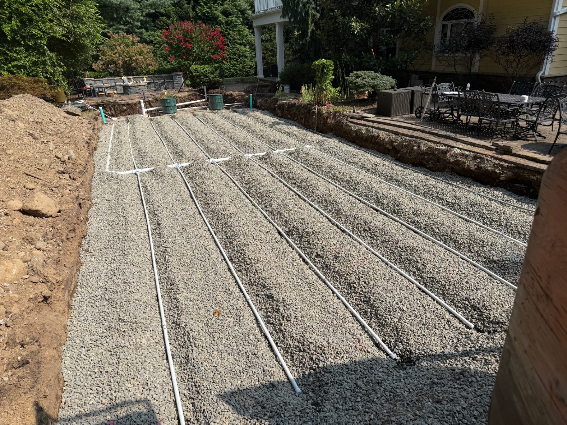 Residential septic disposal field with pressure-dosed laterals on a stone bed